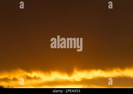 Orange colour background sky with clouds and late afternoon sunlight, Victoria, Australia. Stock Photo