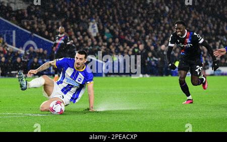 Brighton, UK. 15th Mar, 2023. Lewis Dunk of Brighton and Hove Albion makes a sliding clearance from the attempted shot by Naouirou Ahamada of Crystal Palace during the Premier League match between Brighton & Hove Albion and Crystal Palace at The Amex on March 15th 2023 in Brighton, England. (Photo by Jeff Mood/phcimages.com) Credit: PHC Images/Alamy Live News Stock Photo