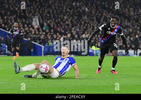 Brighton, UK. 15th Mar, 2023. Lewis Dunk of Brighton and Hove Albion makes a sliding clearance from the attempted shot by Naouirou Ahamada of Crystal Palace during the Premier League match between Brighton & Hove Albion and Crystal Palace at The Amex on March 15th 2023 in Brighton, England. (Photo by Jeff Mood/phcimages.com) Credit: PHC Images/Alamy Live News Stock Photo