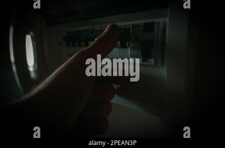Male hand using fuse board relay. Stock Photo