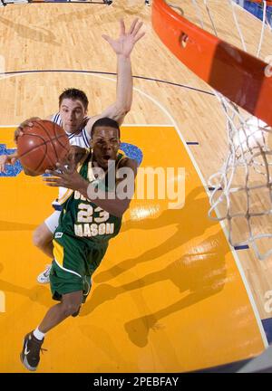 George Mason guard John Vaughan 23 drives to the basket as North