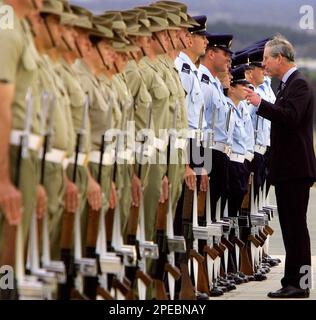 Britain's Prince Charles (R) speaks to Australian military personnel as he walks along the line during his ceremonial arrival in Canberra Friday, March 4, 2005. Royal fever has been sweeping Australia as Britain's Prince Charles and Denmark's Crown Prince Frederik and Crown Princess Mary criss-cross the continent this week. (AP Photo/David Gray, Pool)