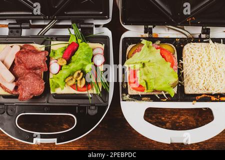 Vegetarian and meat-eating sandwich. Comparison. Sandwich stuffed with meat  sausages and ham against a stuffing of lettuce, onion, olives and tomato  Stock Photo - Alamy