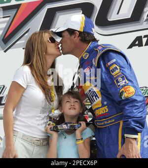 Driver Michael Waltrip and his wife Buffy watch the pre-race show