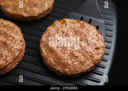 Tasty fried hamburger patties on grill pan, closeup Stock Photo