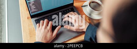 Back view of developer programmer freelancer working on project in cafe. Blurred background Stock Photo
