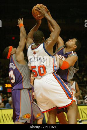 Phoenix Suns' Jim Jackson, left, shoots over Dallas Mavericks' Erick  Dampier during the fourth quarter of Game 5 of their Western Conference  semifinal series Wednesday, May 18, 2005, at America West Arena