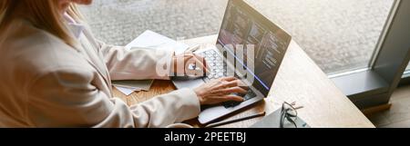 Woman freelance programer working on laptop while sitting in cafe. Data done right Stock Photo