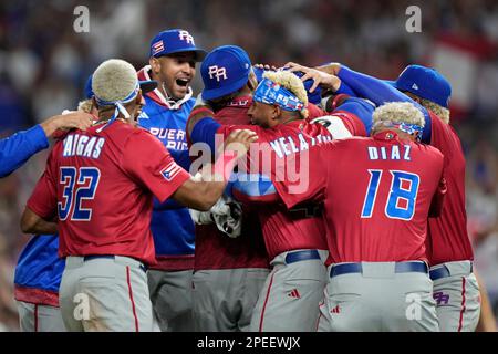 Puerto Rico pitcher Edwin Diaz (39) is being helped by team pitching coach  Ricky Bones and medical staff after the the Pool D game against Dominican  Republic at the World Baseball Classic