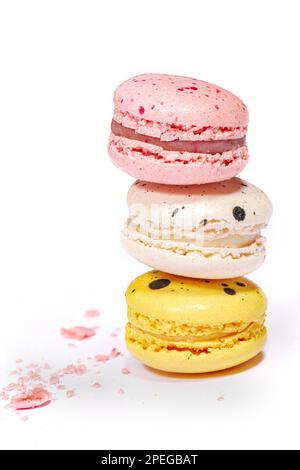 Sweet macaroons macarons stack isolated on white background. French cookies with vanilla, lemon and strawberry. Pastry shop card Stock Photo