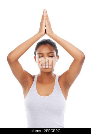Finding her centre. A pretty young woman performing a yoga routine to relax her body and mind. Stock Photo