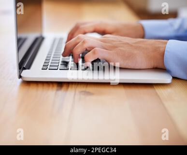 Hard work brings rewards. Cropped image of a business working on his laptop. Stock Photo