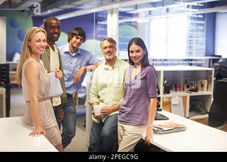 Were number one. Cropped portrait of a group of businesspeople standing in their office. Stock Photo