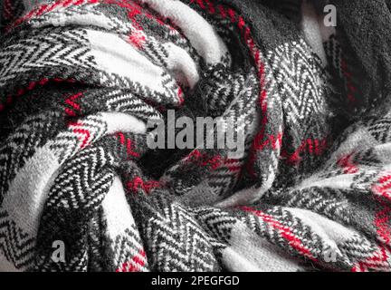 Knit texture of natural soft wool knitted fabric black white red as background Stock Photo
