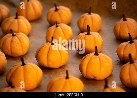 Halloween cookie with pumpkin and cinnamon baking paper background Stock Photo