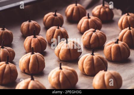 Halloween cookie with pumpkin and cinnamon baking paper background Horror style Stock Photo