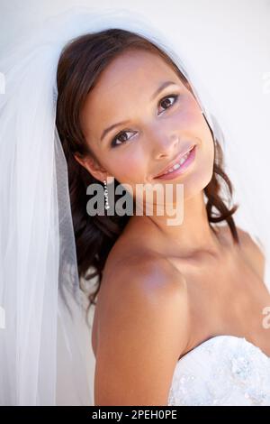 Loving every moment of this day. Portrait of a beautiful young bride smiling at the camera. Stock Photo