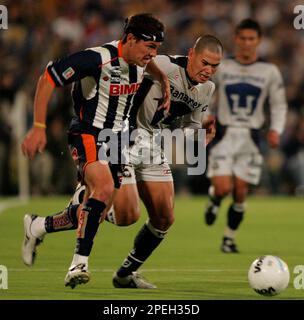 Dario Veron, left, of Pumas, fights to head the ball against Guillermo  Franco of Monterrey during the first game of the Mexican soccer championship  final at the University Stadium in Mexico City