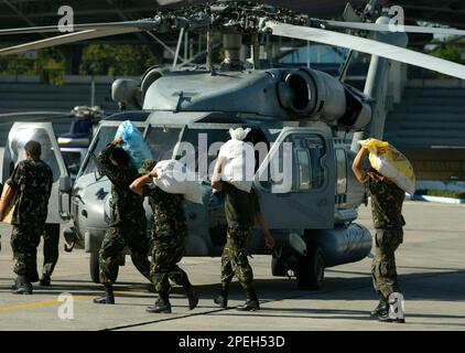 Filipino Soldiers Load Relief Supplies Onto A US Navy HH-60 Seahawk ...