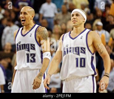 Sacramento Kings guard Doug Christie (13) gets past Los Angeles Clippers  guard Eric Piatkowski, right, for a lay up during the second half in  Sacramento, Calif., Tuesday, March 26, 2002. The Kings