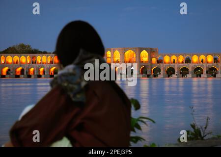 Isfahan, Iran - 15th june, 2022: tourist visit look at famous travel destination in Iran - Old Khajoo bridge, across the Zayandeh River in Isfahan, Ir Stock Photo