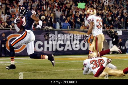 Chicago Bears receiver Bernard Berrian, right, focuses on a 33