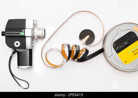 old 8mm film camera and film roll on white background. Stock Photo