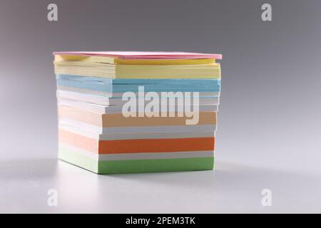 Stack of multicolored sticky notes on gray background Stock Photo