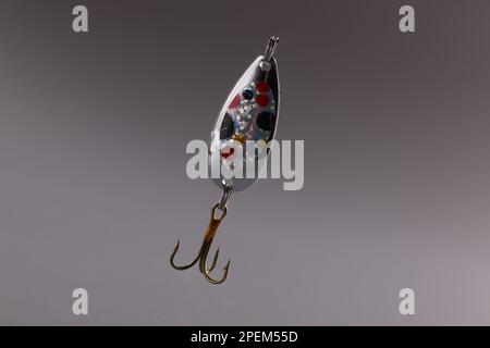 Fishing tackle with bait and hook on gray background Stock Photo