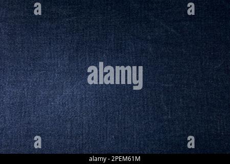 Black jeans fabric background texture. Black jeans fabric cloth textile material. Stock Photo