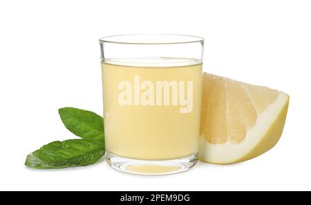 Glass of fresh pomelo juice, fruit and green leaves isolated on white Stock Photo