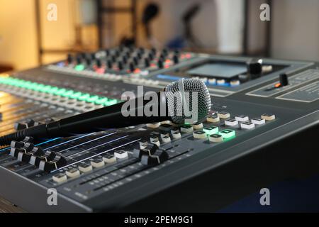 Microphone on professional mixing console in radio studio Stock Photo