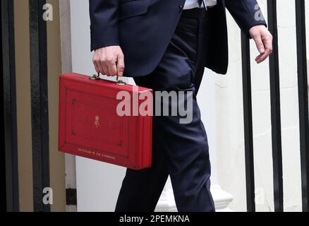 London, UK. 15th Mar, 2023. Jeremy Hunt, the Chancellor of the Exchequer, keeps a tight grip on the red budget box as he leaves Number 11 Downing Street before he delivers his Budget speech in The House of Commons at lunchtime. Budget Day, Downing Street, Westminster, London, on 15th March, 2023. Credit: Paul Marriott/Alamy Live News