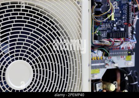 Air conditioner with open electronics control unit. Selective focus. Stock Photo