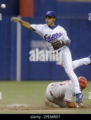 Montreal Expos shortstop Maicer Izturis, right, applies the tag to pick off  Chicago Cubs Mark Grudzielanek at second base during third inning NL action  in Montreal on Monday, Aug. 30, 2004. (AP