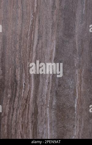 Texture and background of a dark brown marble slab with vertical stripes. Stock Photo