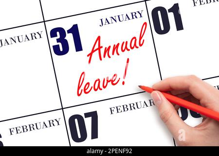 31st day of January. Hand writing the text ANNUAL LEAVE and drawing the sun on the calendar date January 31. Save the date. Time for the holidays. vac Stock Photo