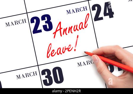 23rd day of March. Hand writing the text ANNUAL LEAVE and drawing the sun on the calendar date March 23. Save the date. Time for the holidays. vacatio Stock Photo