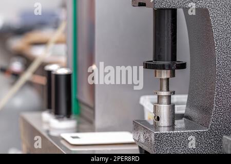 closed with the lid of beverage cans in an automatic capping machine in a brewery Stock Photo