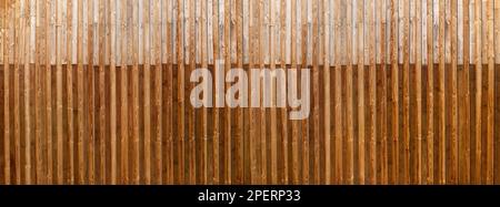 Two-tone brown panoramic wooden wall made of vertical laths Stock Photo