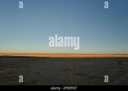 A wide picture of the endless Sahara desert with a moon in daylight Stock Photo