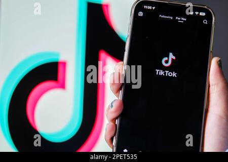 London, UK. 16th March 2023. Tik Tok's logo on a smartphone in front of itÕs log on a computer screen. Cabinet Office minister Oliver Dowden will later today announce a ban on the Chinese social media app Tik Tok on all devices for its government ministers and civil servants working within government. The US government and EU Commission have already banned the app due to security concerns. There are fears that Chinese social media app TikTok may be totally ban in the UK. Credit: Dinendra HariaAlamy Live News Stock Photo