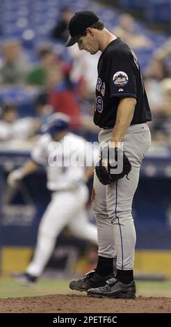 Montreal Expos starting pitcher Scott Downs, left, wipes his forehead as is  teammatesTony Batista, Maicer Izturis and Alex Gonzalez return to play  after the Atlanta Braves scores two runs during third inning