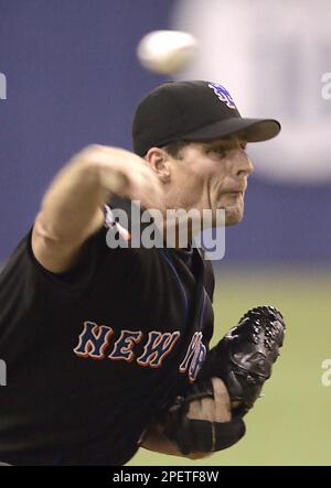 Montreal Expos starting pitcher Scott Downs, left, wipes his forehead as is  teammatesTony Batista, Maicer Izturis and Alex Gonzalez return to play  after the Atlanta Braves scores two runs during third inning