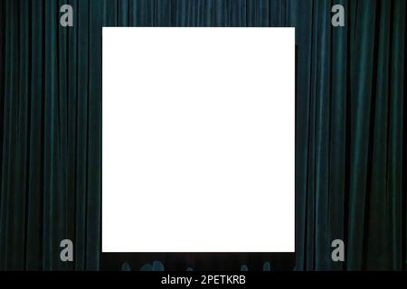 Frame with copy space for text hanging on the wall with dark green curtains. Mockup for design. Vacant poster. Stock Photo