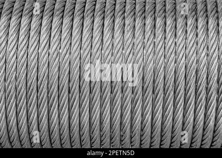 The texture of a new stainless steel cable wrapped in a spool. Abstract background for desin. Stock Photo