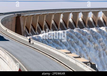 Gariepdam, South Africa - Feb 21, 2023: The largest dam in South Africa, the Gariep Dam, overflowing. It is in the Orange River. People are visible Stock Photo