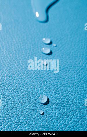 closeup of some drops of water on a blue leather surface Stock Photo