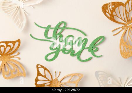 Thank you text with butterfly paper carve on pastel background. Stock Photo
