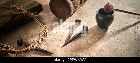 Crucifixion Of Jesus Christ. Cross With three Nails And Crown Of Thorns on ground Stock Photo